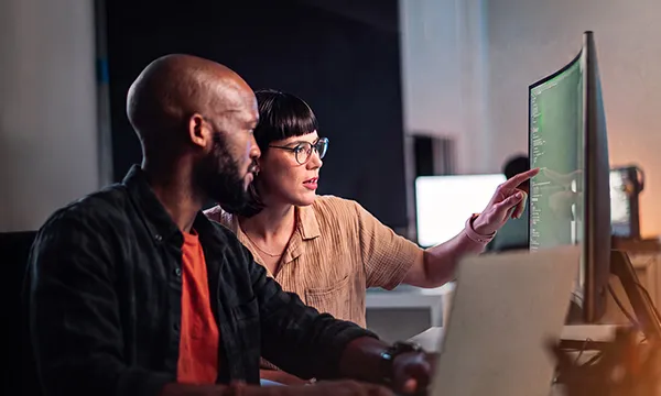 Engineers reviewing AI-driven network analytics on screen