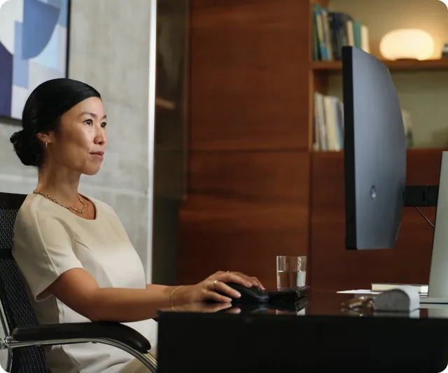 Professional working at a desk with HP EliteDesk Mini and large monitor