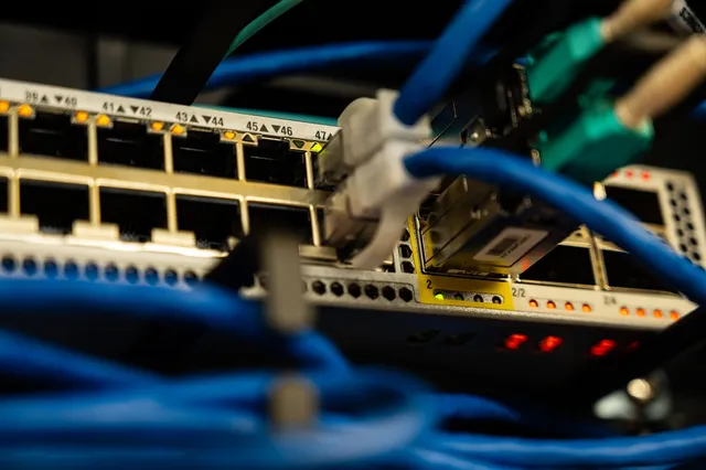 Fibre and copper patch cables connected to a network switch