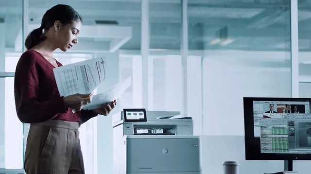 Professional collecting documents from an HP LaserJet Enterprise printer